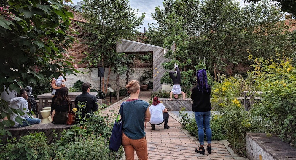 residents watching performance at community garden