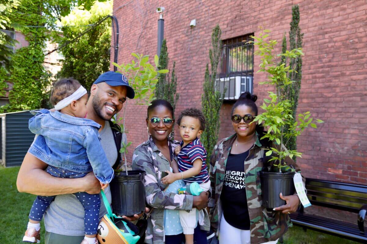 family smiling with free trees