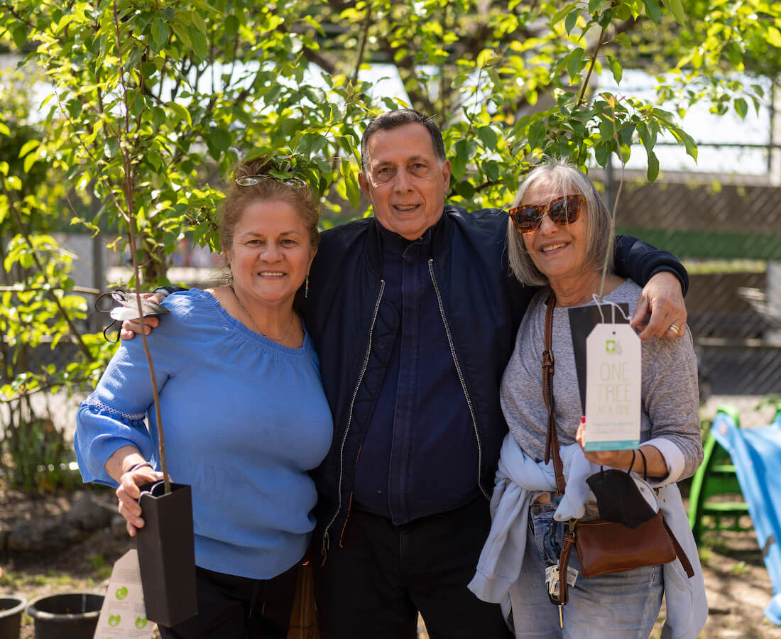 people smiling with tree