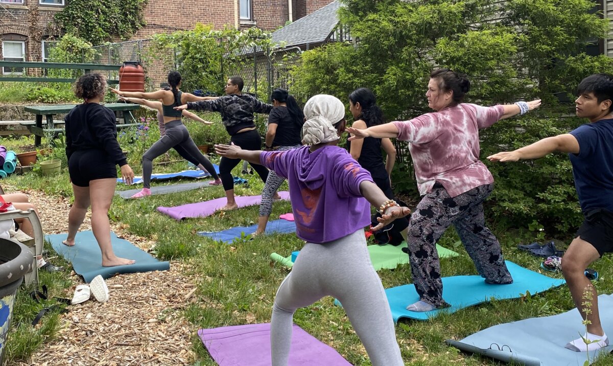 A group of people doing yoga at Westervelt Community Garden