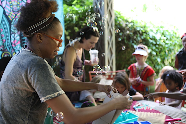 People of all ages gather to do art in the garden
