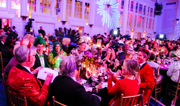 people in costumes dine around a table at the 2022 Hulaween event
