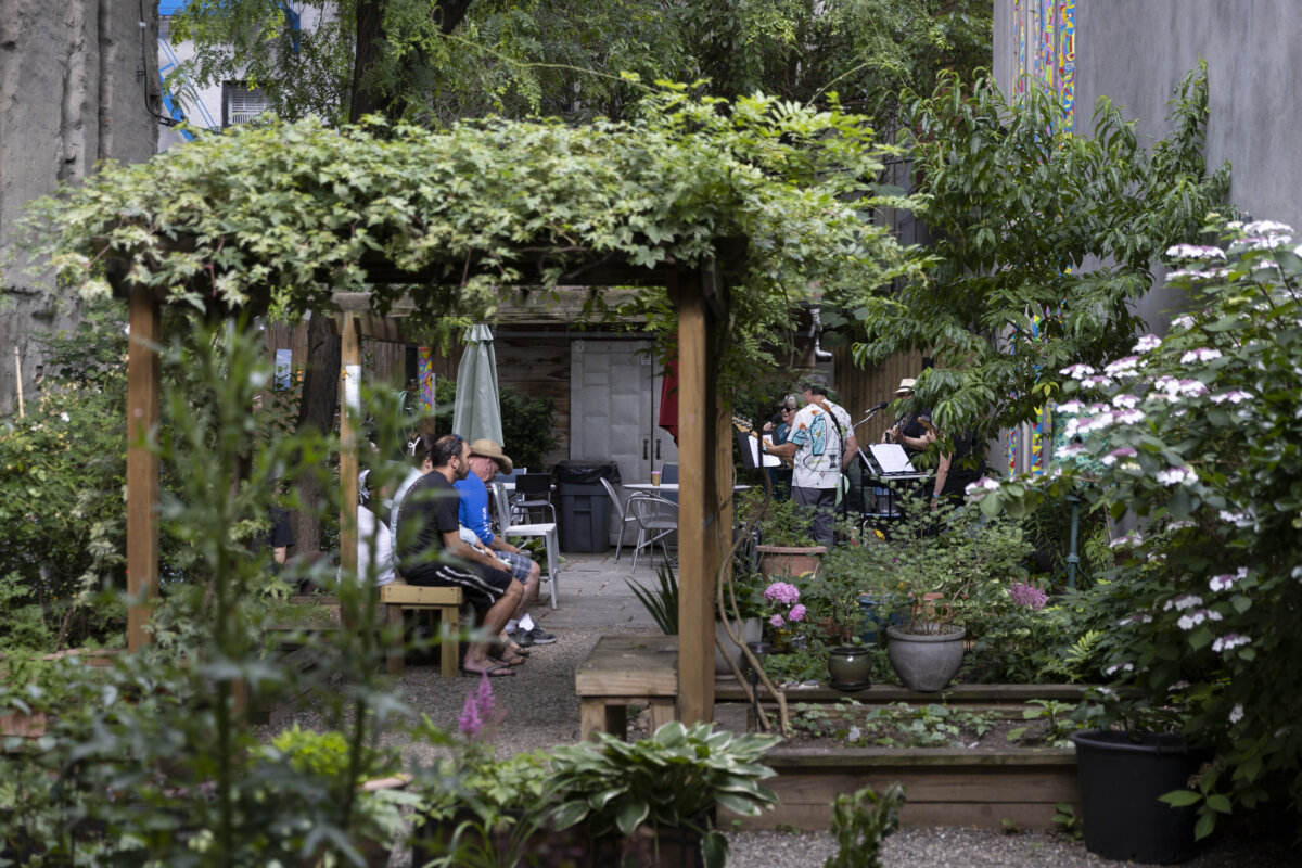 people watch a musical performance in Maggie's Garden