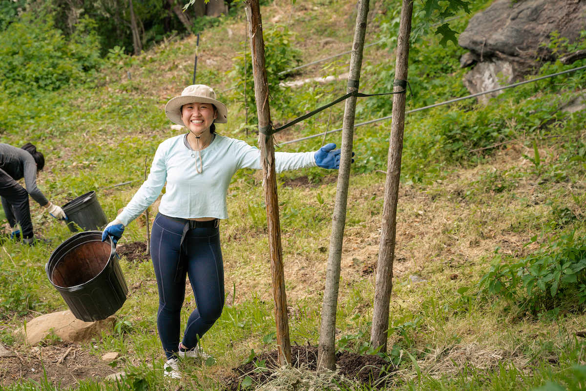 person smiling with tree