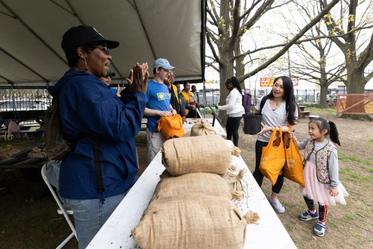 person giving away free tree and compost