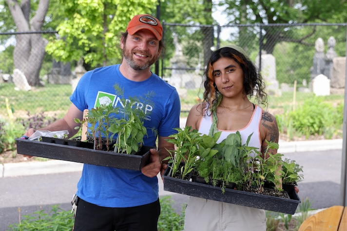 people smiling with plants