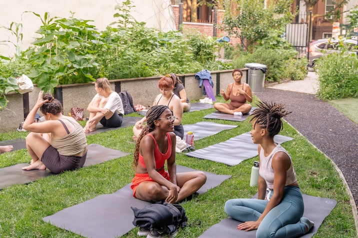 people doing yoga in garden
