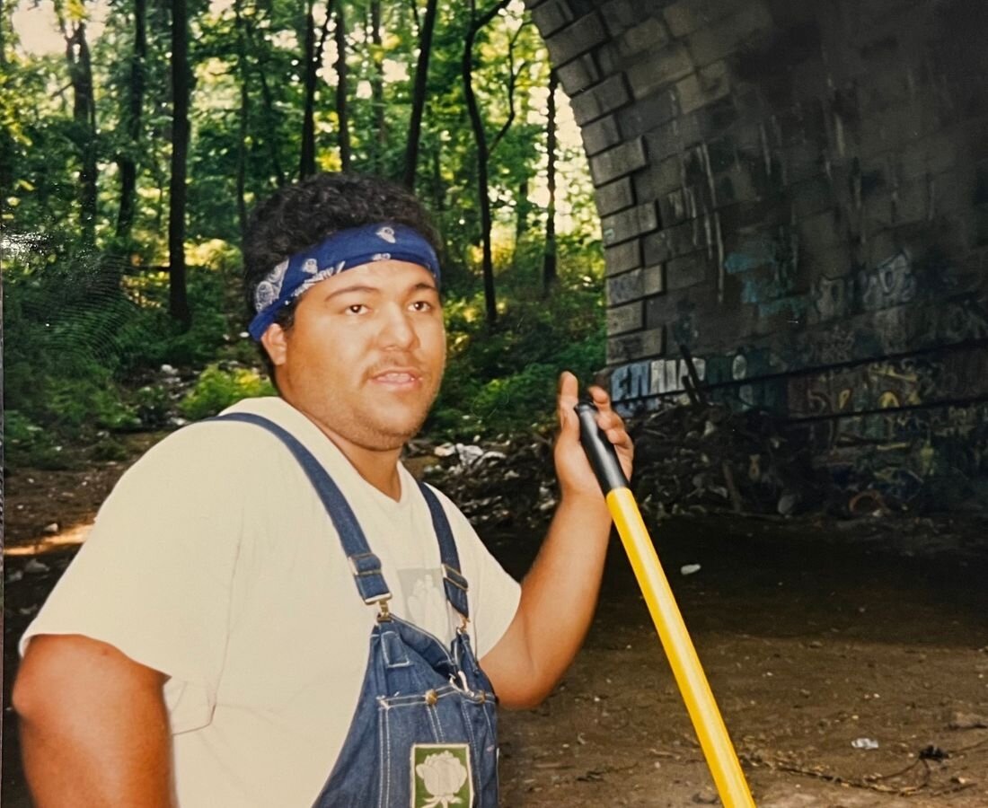person in overalls outside