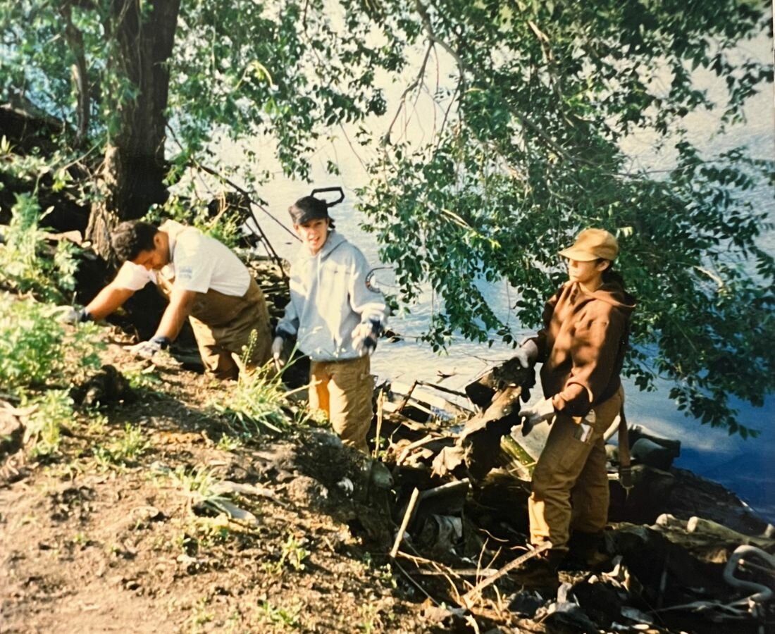 people cleaning up shoreline