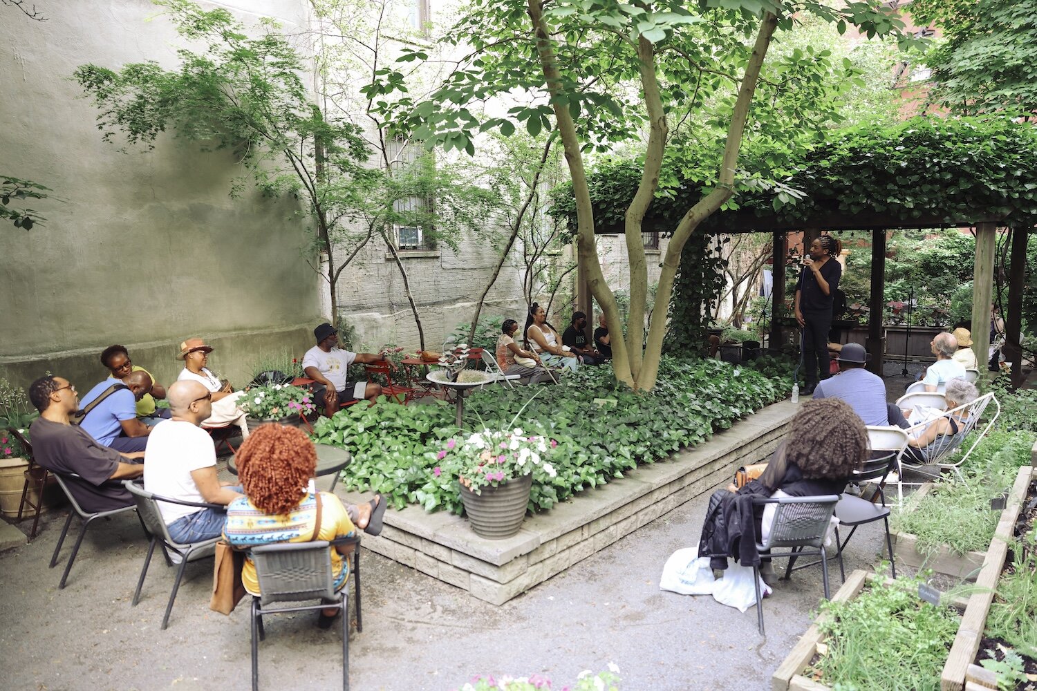 people in garden enjoying concert