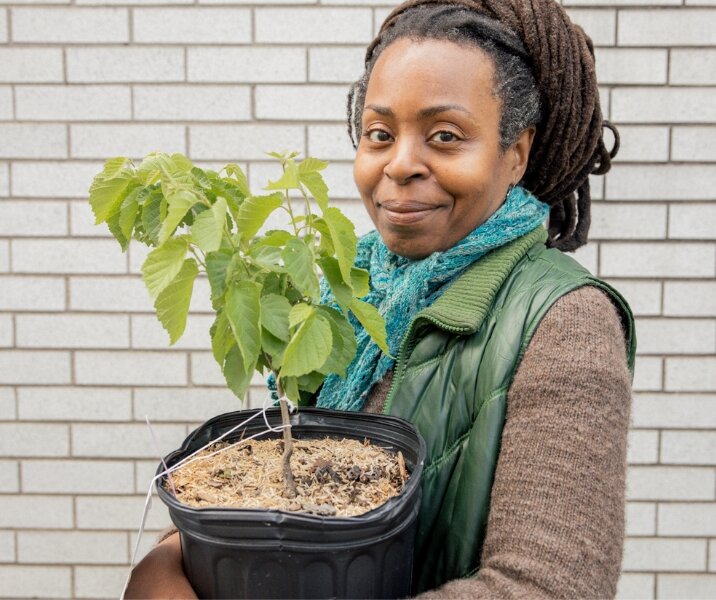Woman posing with a tree