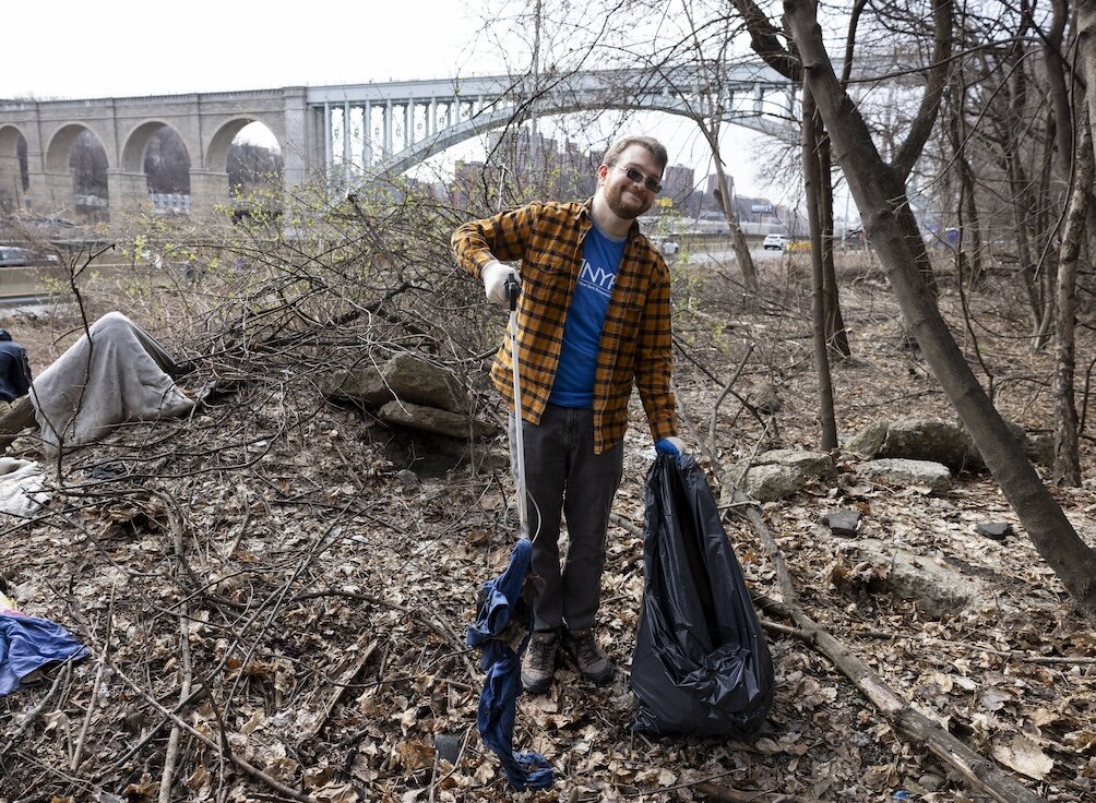 person picking up trash